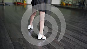 Child girl standing in black sport bodysuit in dancing studio during training posture. 4 5 years old preschool age