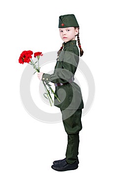 Child girl standing in a uniform with red flowers sideways, on a white background, and looking at you
