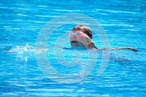 Child  girl swimmer in the pool. Sporting  healthy summer vacation with the kids.