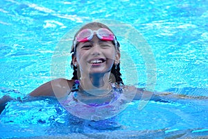 Child  girl swimmer in the pool. Sporting  healthy summer vacation with the kids.