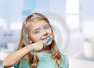 Child girl toddler cleaning teeth in bathroom background.