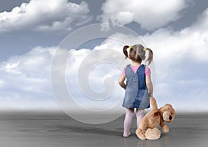 Child girl with toy bear looking into the distance, perception c