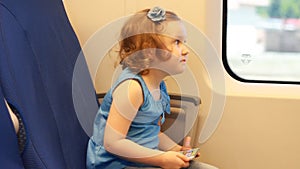 Child girl is traveling by train
