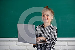 Child girl using gadgets to study. Computer education for kids.