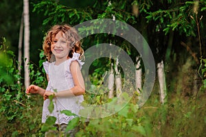 Child girl on the walk in summer forest, nature exploration with kids