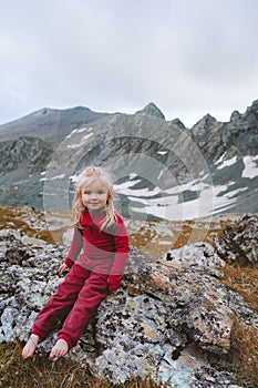 Child girl walking in mountains barefoot happy smiling face family vacations