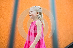 Child girl walks and have fun outdoor with cochlear implant on the head. Hearing aid and treatment concept. Copy space