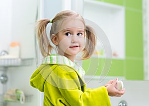 Child girl washing her hands protecting from germs