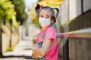 Child girl wearing a protection mask against coronavirus during Covid-19 pandemic