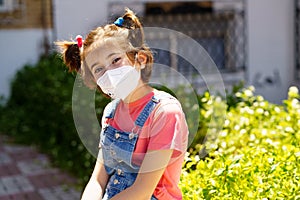 Child girl wearing a protection mask against coronavirus during Covid-19 pandemic