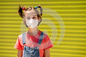 Child girl wearing a protection mask against coronavirus during Covid-19 pandemic