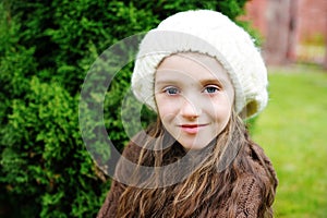Child girl in white cap, close-up portrait