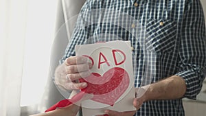 Child giving a gift box for lovely father