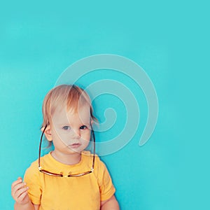 Child with glasses hanging on his ears