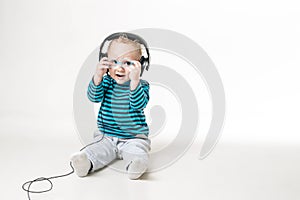 Child with glasses sits at a table on the background of the table for an eye examination