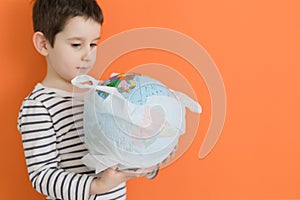 Child with globe in plastic bag