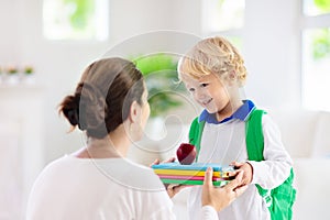 Child going back to school. Mother and kid