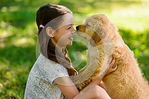 Child and golden retriever puppy