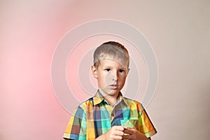 Child on a gradient colored background in a multi-colored shirt