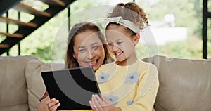 Child, grandma or tablet as gaming, app or technology as online, learning or fun on sofa in home. Elderly woman or girl