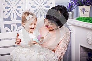 Child and grandmother with Easter eggs