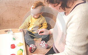 Child with grandmother playing indoors