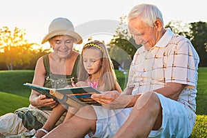 Child with grandparents, photo album.