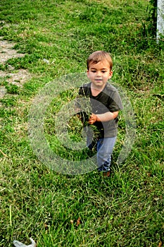 Child with grass in his hands