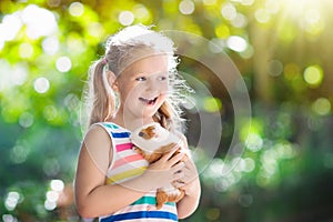 Child with guinea pig. Cavy animal. Kids and pets.