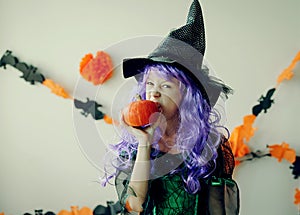 Child in Halloween costume. Kids trick or treat. Little boy with pumpkin lantern. Girl in witch hat.