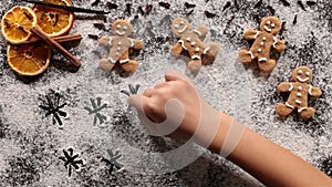 Child hand drawing in the flour of christmas cookies