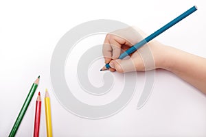 Child hand draws a blue pencil photo