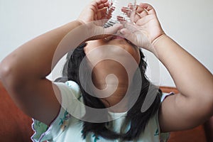 child hand holding a glass of water