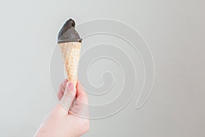 Child hand holding ice cream with room for text