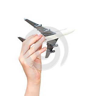 Child hand holding model airplane.