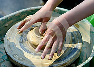 child hand makes the clay modelling