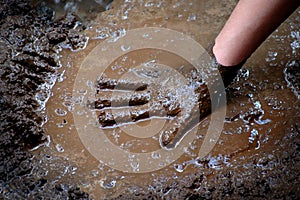 Child Hand in Mud and Water Playing Muddy Wet