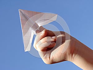 Child hand with paper plane