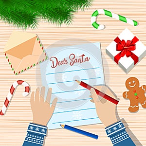 Child Hand with pen Writing letter to santa claus.