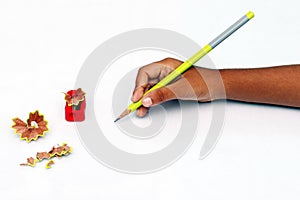 Child hand with pencil and sharpener.