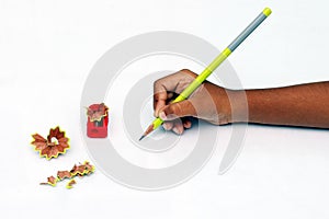 Child hand with pencil and sharpener.