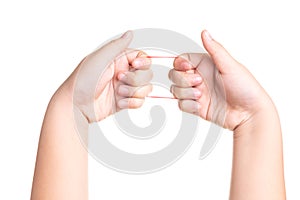 Child hand playing with elastic rubber band isolated on white