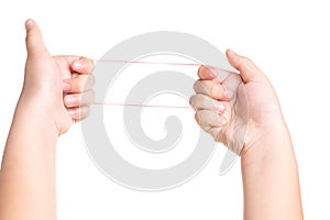Child hand playing with elastic rubber band isolated on white