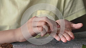 Child hand pouring homeopathic pills or globules from a bottle into the palm