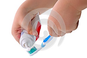 Child hand and toothpaste