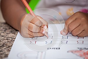 Child hand writing her homework