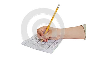 Child hand writing on sudoku game