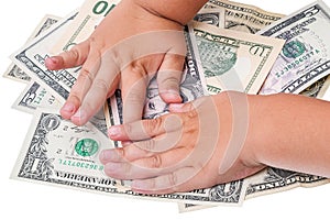 Child hands and cash US dollars