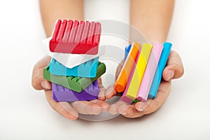 Child hands with colorful modeling clay