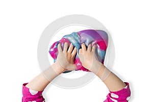 Child hands and colorful pink, blue and purple shiny slime